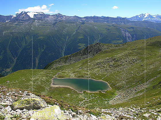 Foto: Im Abstieg vom Risihorn. Blick auf den Spilsee mit Rappehorn, Schweifegrat und Scherbadung im Hintergrund.