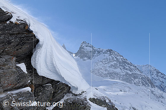 Foto: Felsvorsprung mit Wächte und Schneefahne. Im Hintergrund ist das Seewischhorn zu sehen.