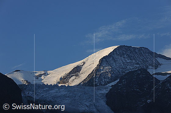 Foto: Gwächtenhorn und Steigletscher mit Seraczone. Morgenstimmung mit Licht und Schatten am Gipfel des Gwächtenhorns. Die Eistürme im Schatten heben sich vom Gletschereis im Morgenlicht ab.