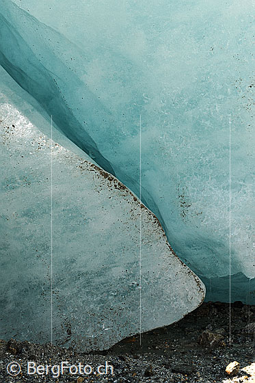 Foto: Schmale Spalte im Gletschereis. Das Eis leuchtet in einem magischen Hellblau.