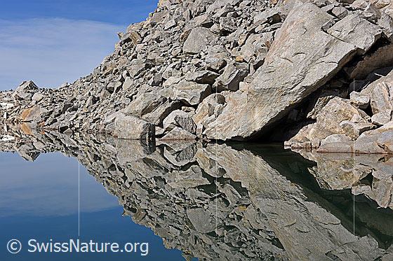 Foto: Spiegelung eines Geröllfeldes in Bergsee.