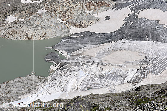 Foto: Gletscherabdeckungen am Rhonegletscher (Stand 7.2019). Die Abdeckungen verlangsamen das Abschelzen des Gletschers. Unter den Abdeckungen bedindet sich die von Menschen erstellte Eisgrotte.

